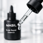 Close-up of clear, non-greasy concentrated liquid of Masil Scalp Repair Essence in a glass dropper.