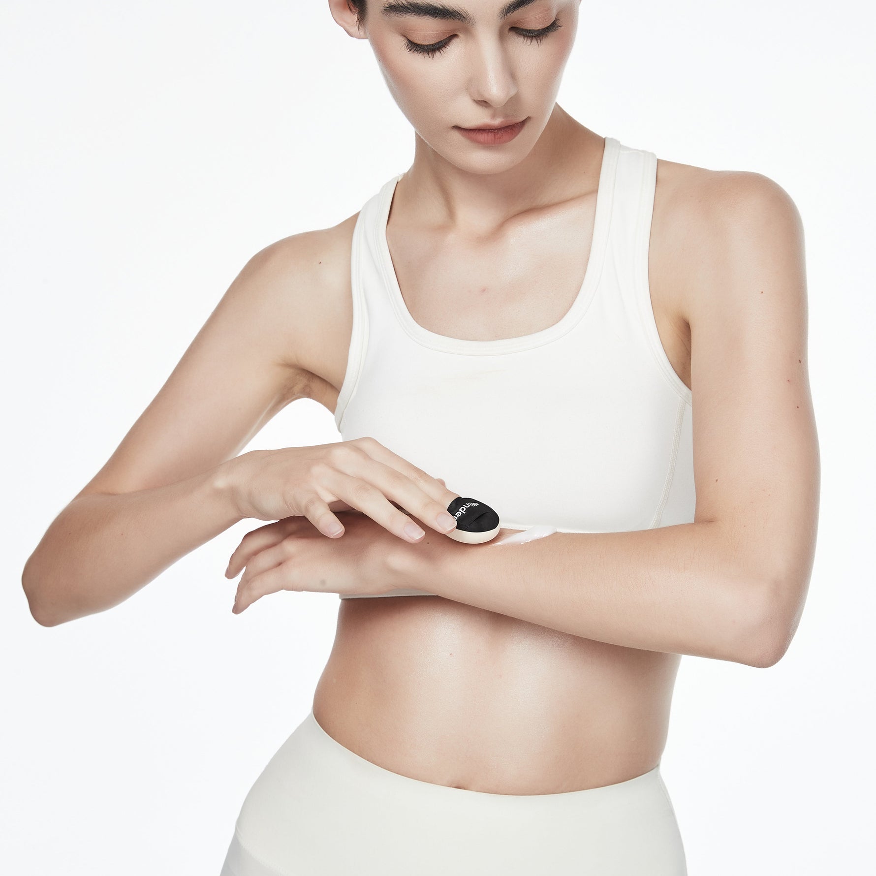 applying body lotion with a puff applicator for precise and even coverage