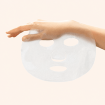 A hand gently holding a thin, translucent Soso Hydrating Soothing Mask sheet, showcasing its feather-light and breathable texture. The mask is designed for seamless skin-hugging fit, emphasizing its delicate and effective material for optimal absorption.